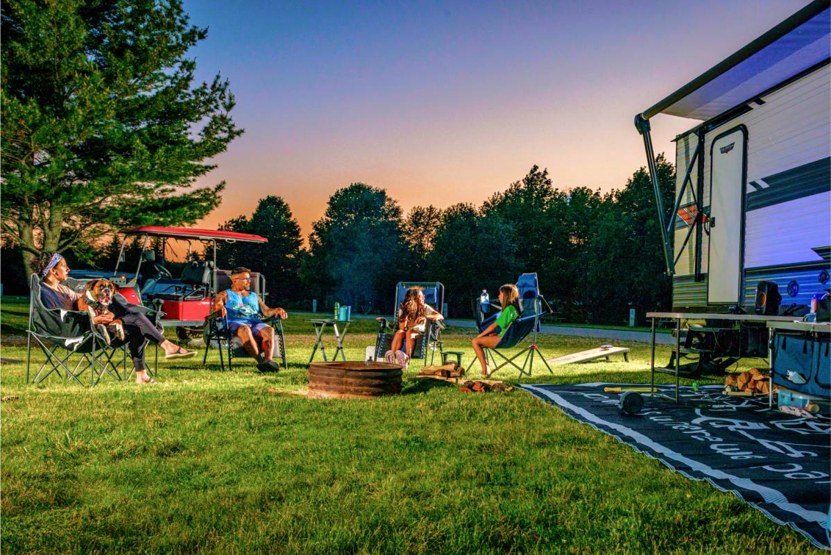 Family around campfire at Campground